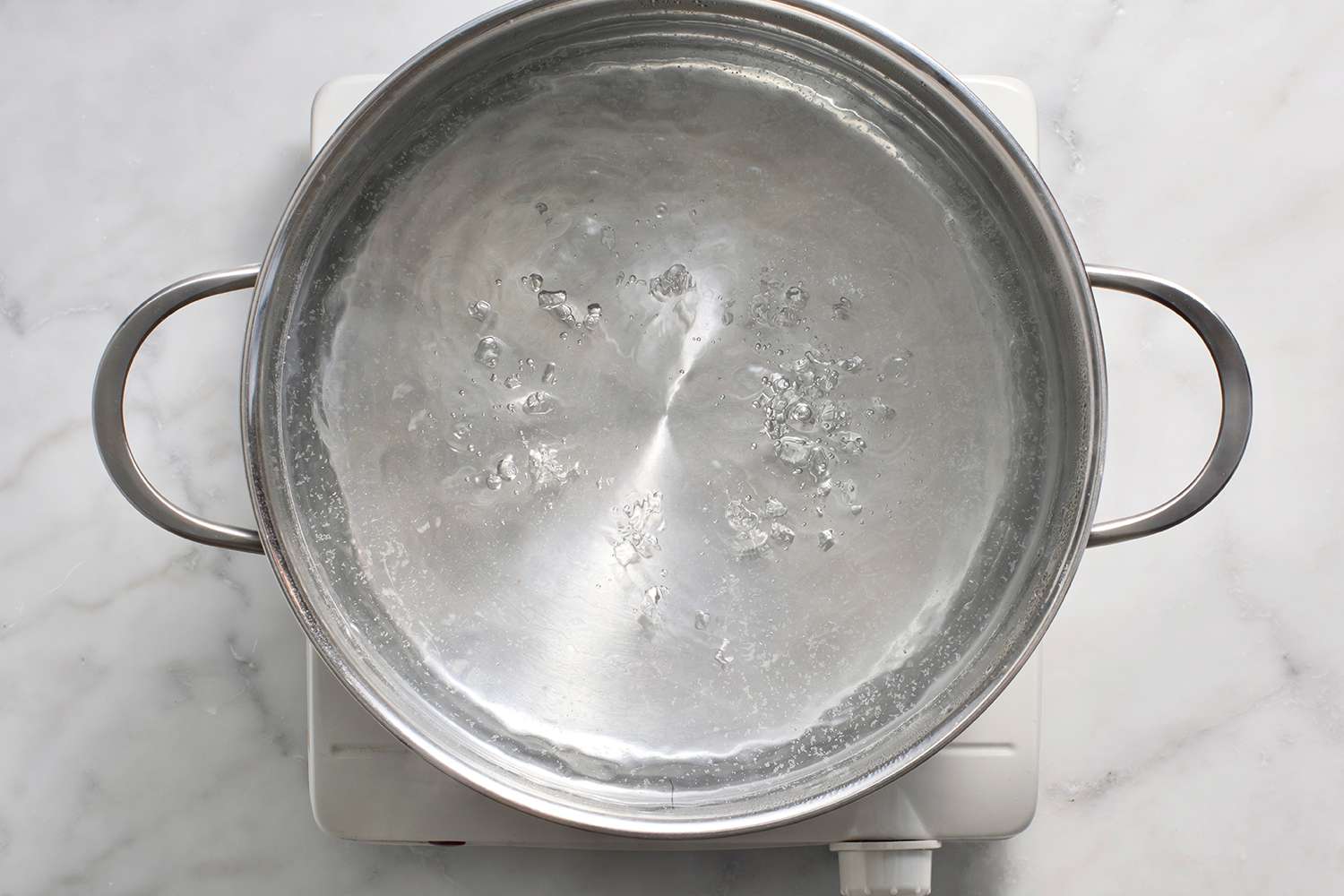 Water boiling in a pot, on a burner 