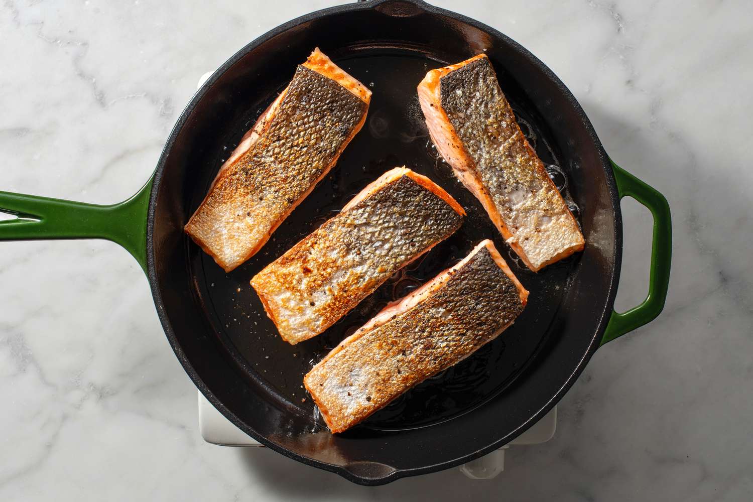 A pan of seared, skin-side up salmon