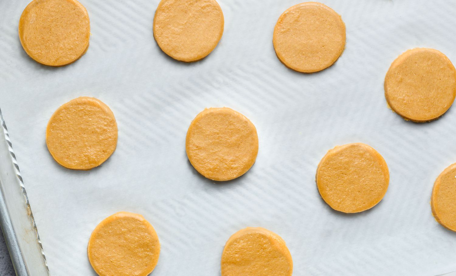 circle cookies cut out and placed on prepared baking sheet
