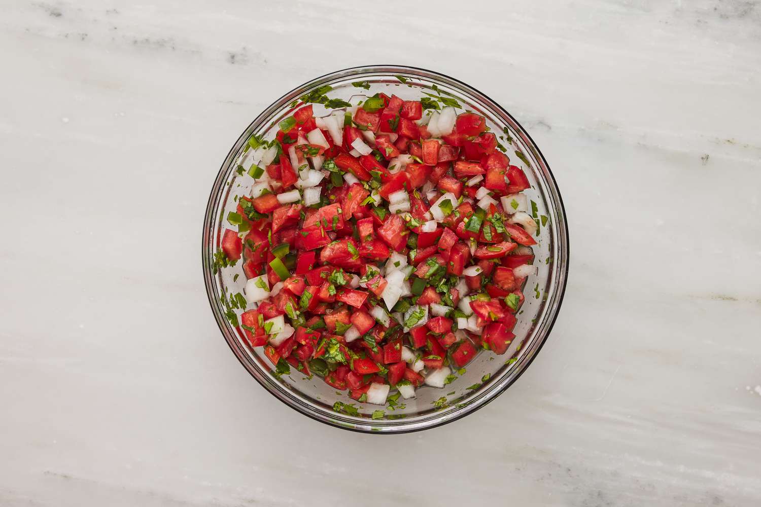 pico salsa ingredients combined in a bowl