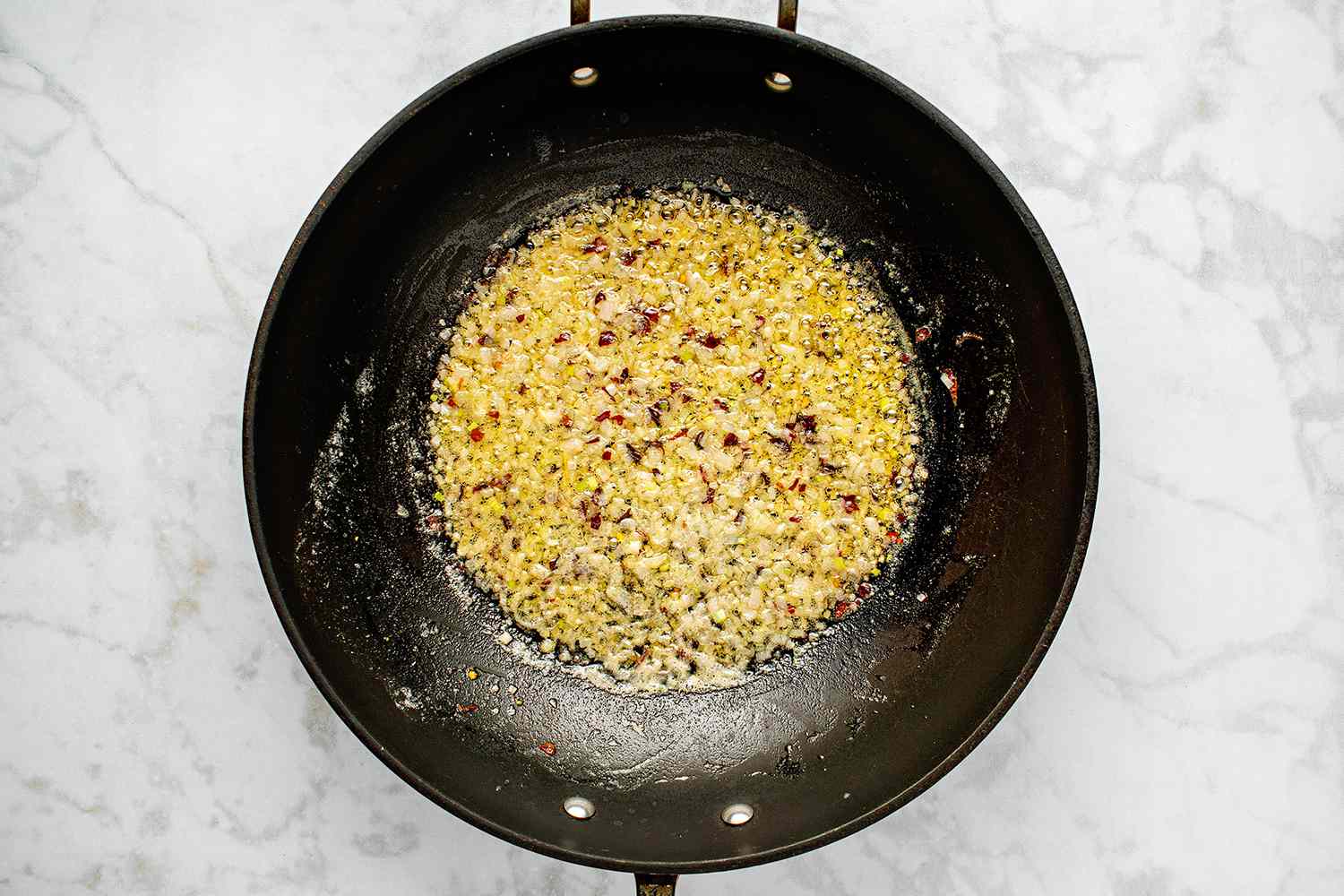 Shallot and crushed red pepper in a pan 
