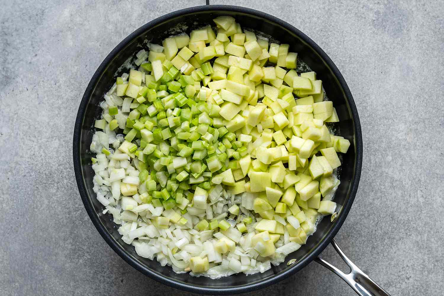 chopped onions, celery and apple in a skillet