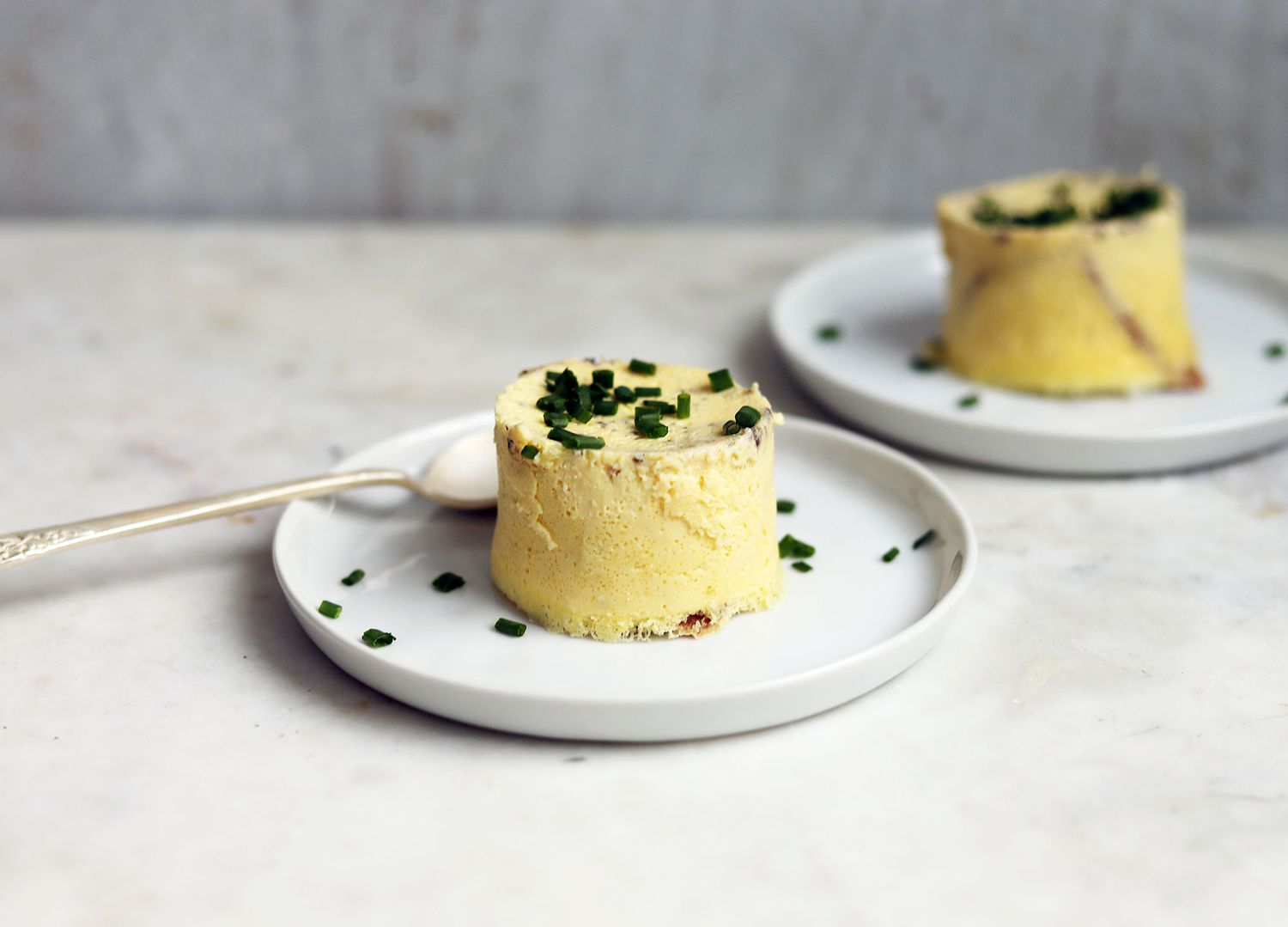 sous vide egg bites on plates with chives