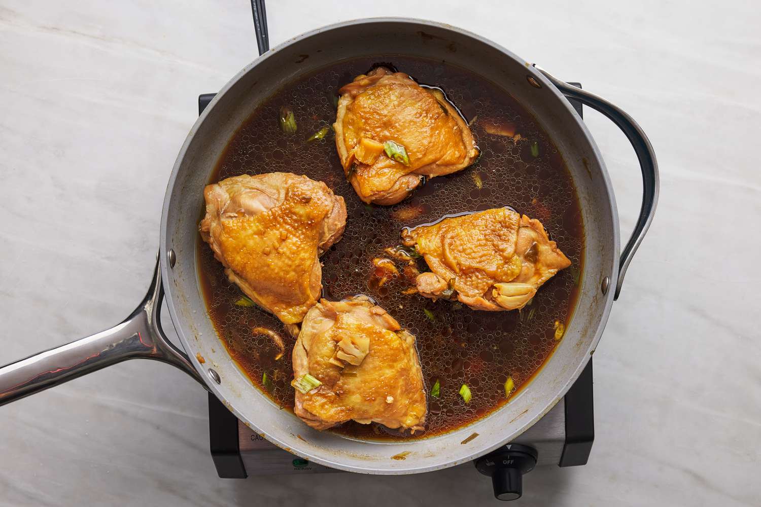chicken thighs in shoyu sauce in pan 