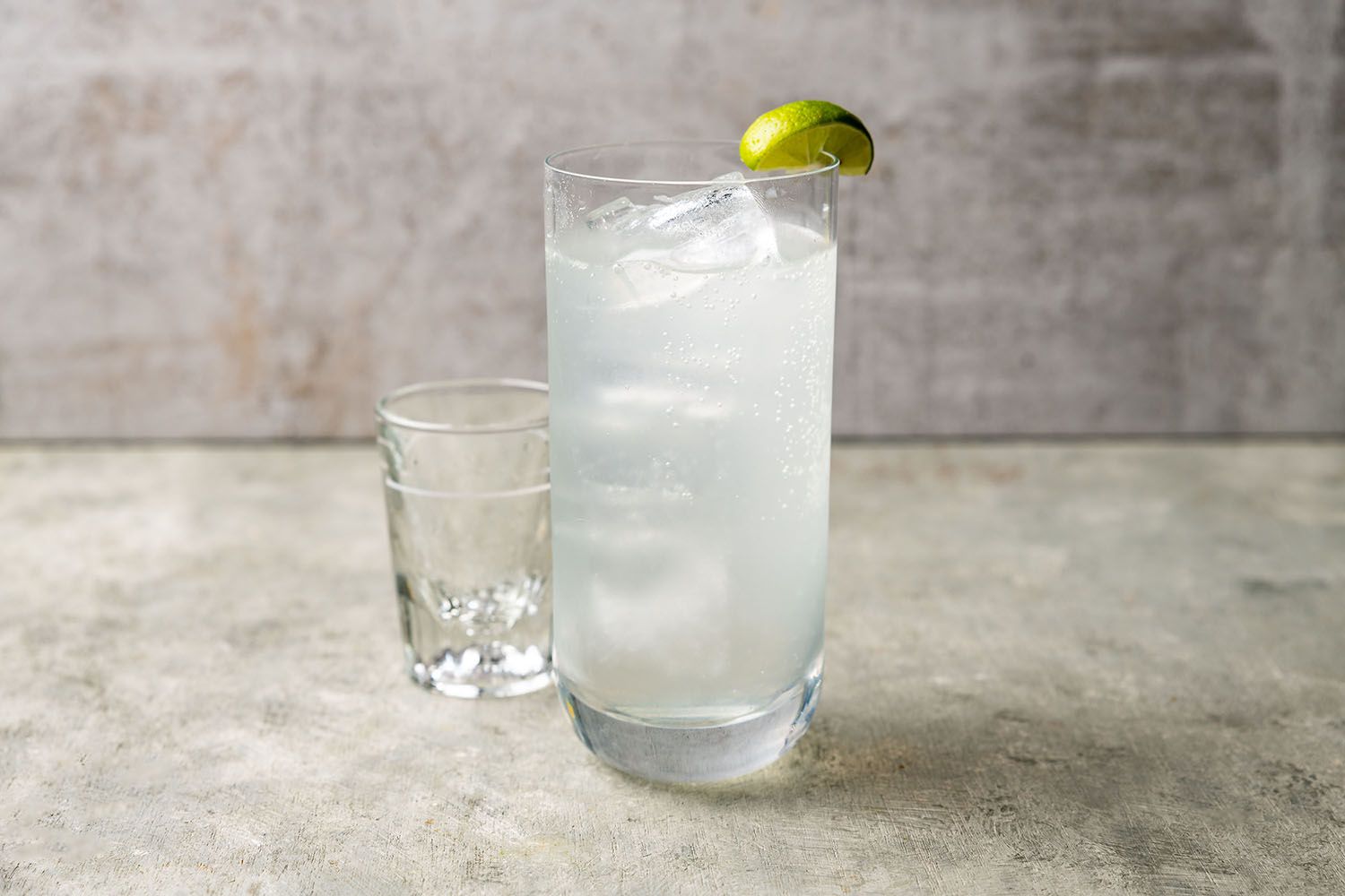 Glass with ranch water and ice garnished with lime. 
