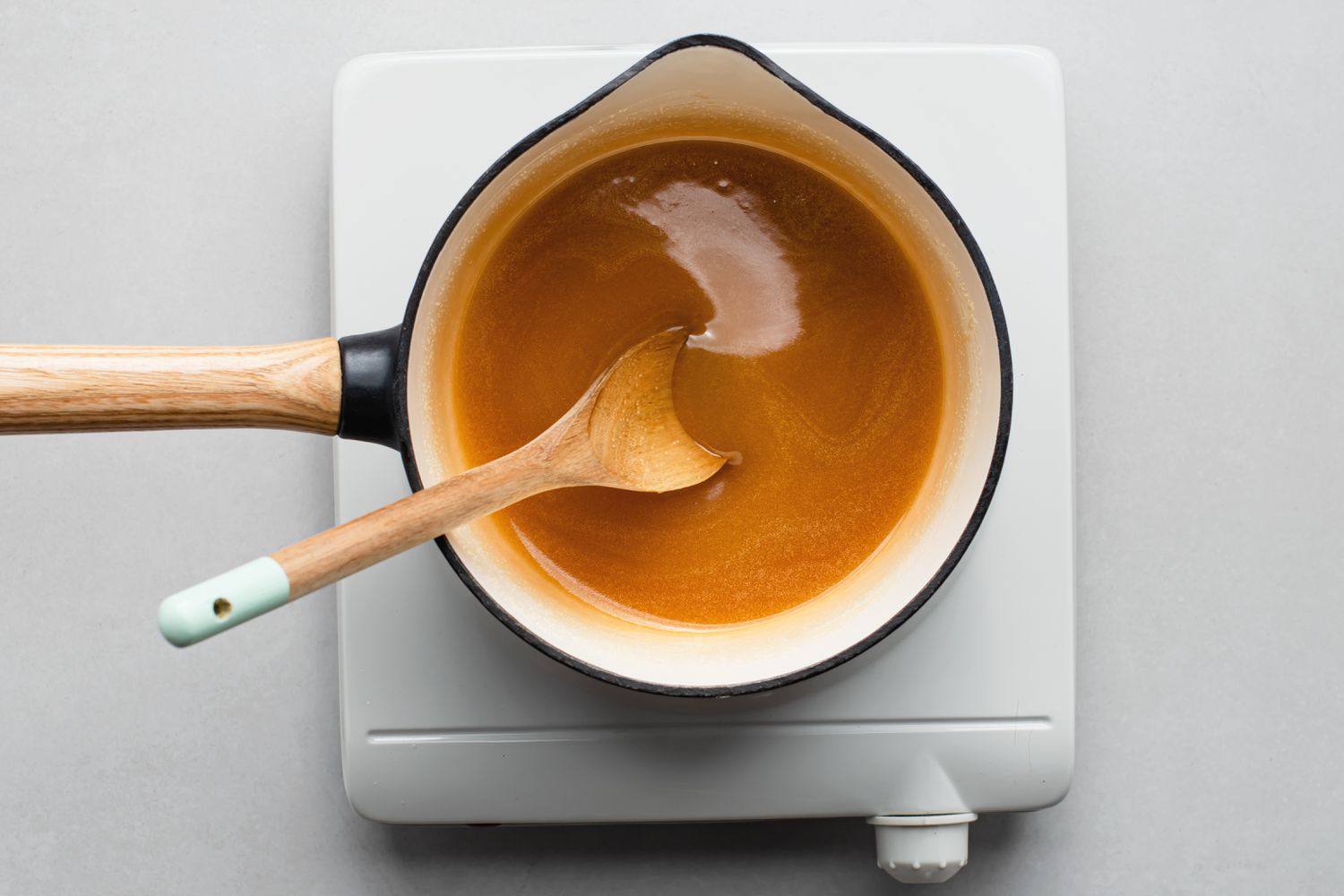 Melting butter, sugar and vanilla in a saucepan for butter cake glaze