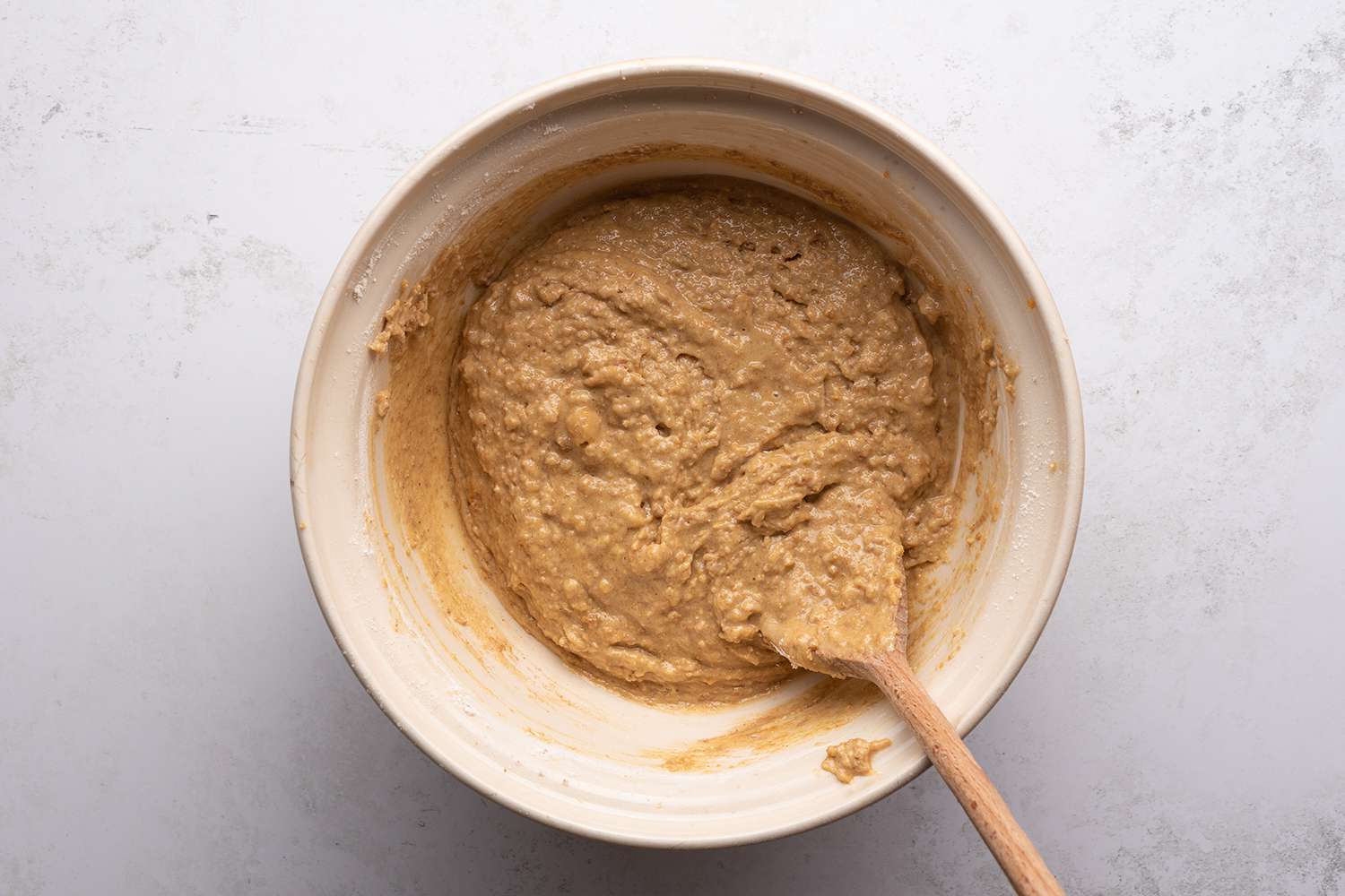 Batter in a bowl with a wooden spoon 