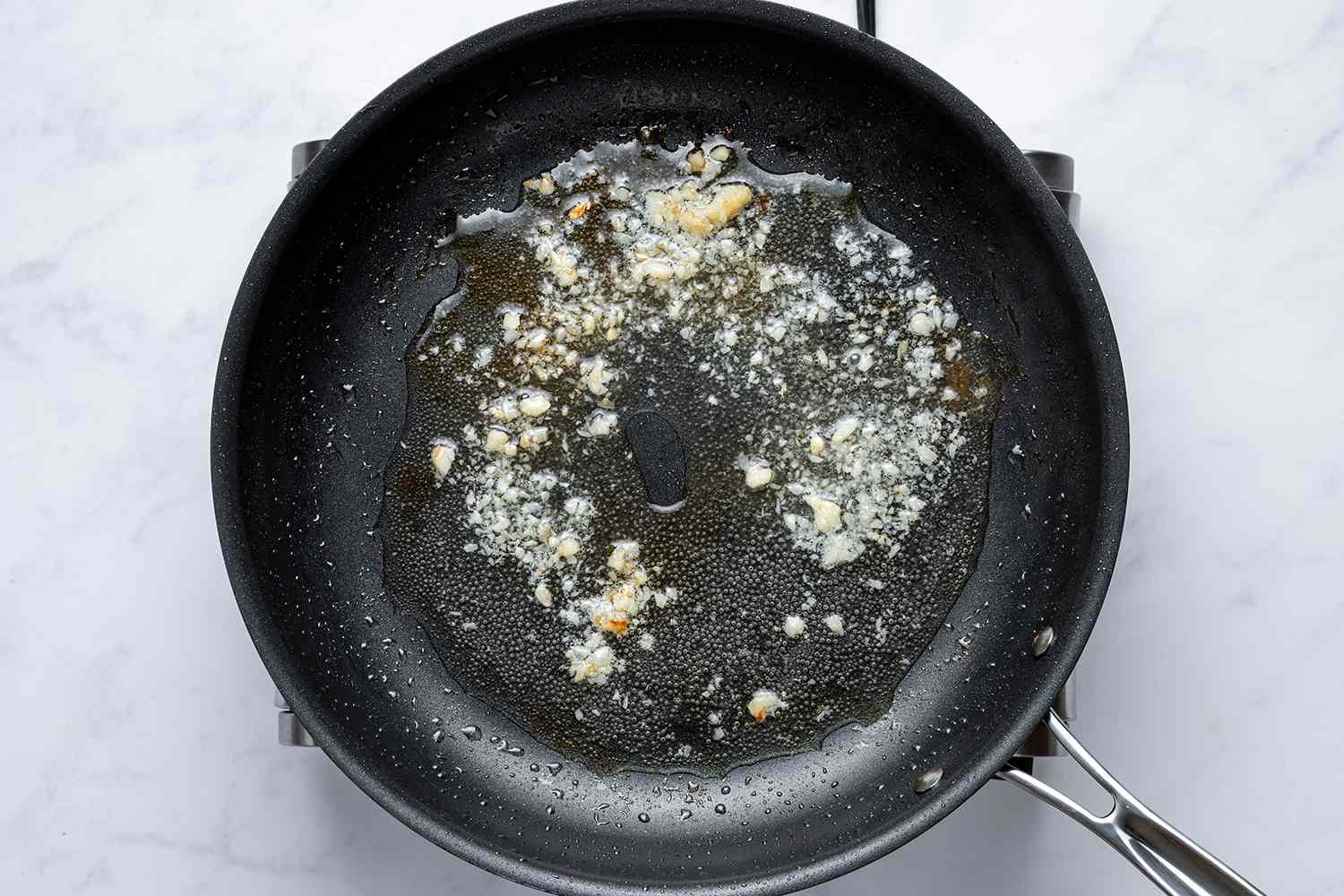Garlic and white wine in a skillet