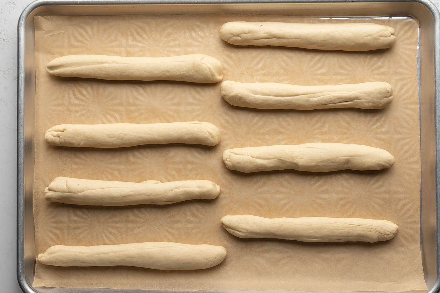 Dough logs on a lined baking sheet 
