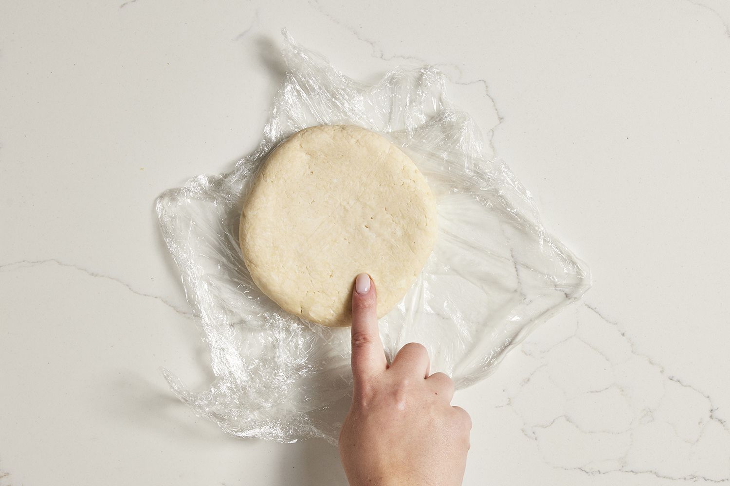 rested dough on plastic wrap