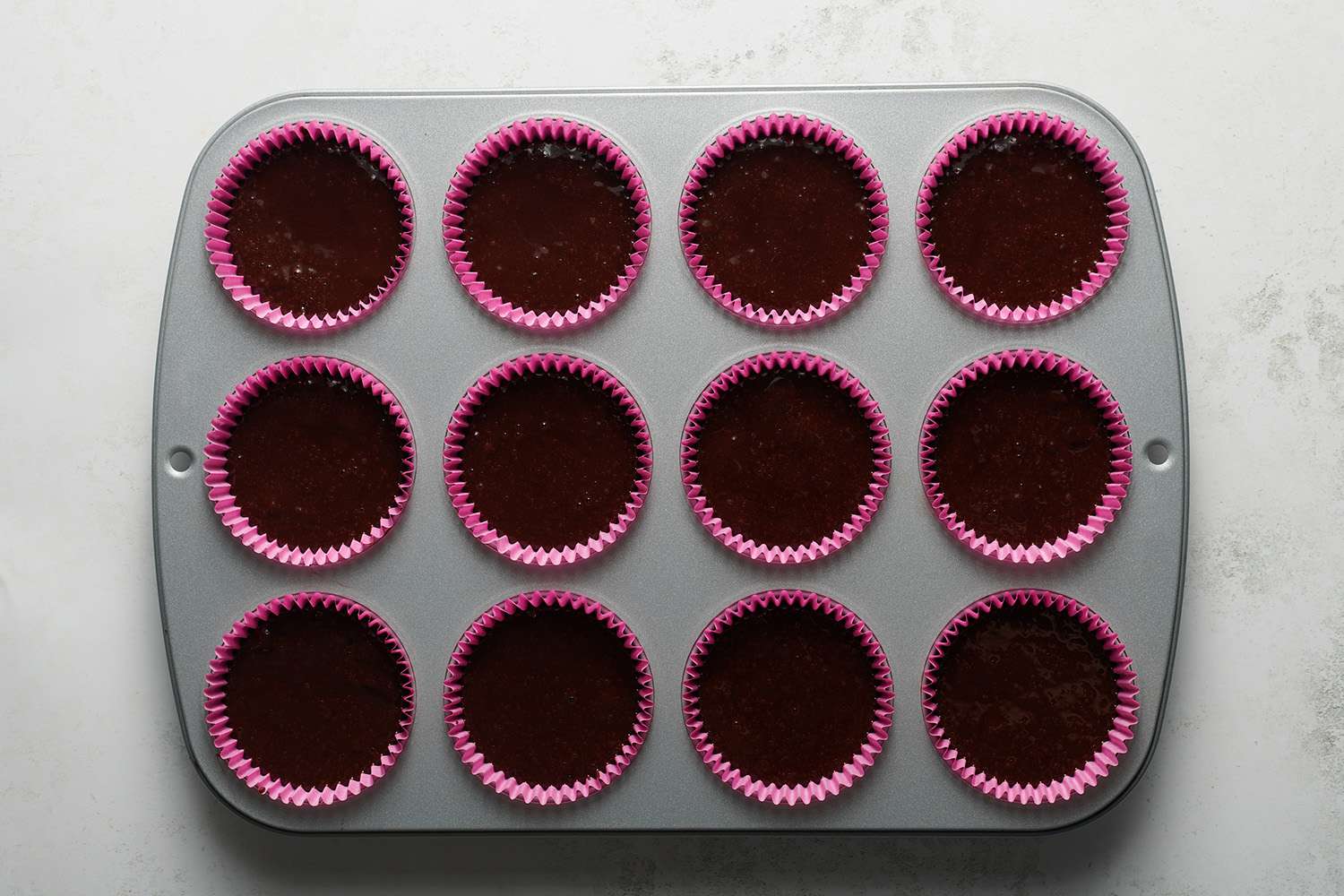 chocolate cupcake batter in cupcake tin