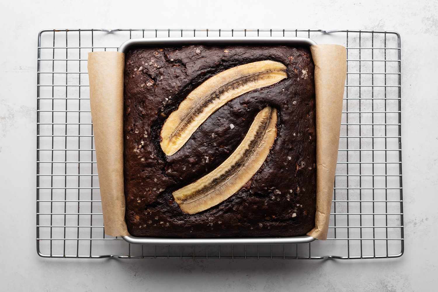 Baked Banana Bread Brownies in a baking pan on a cooling rack 