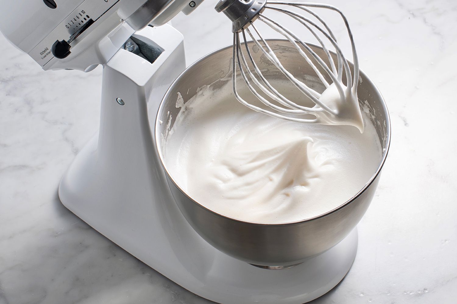 Whipped egg whites with sweetener in a stand mixer 