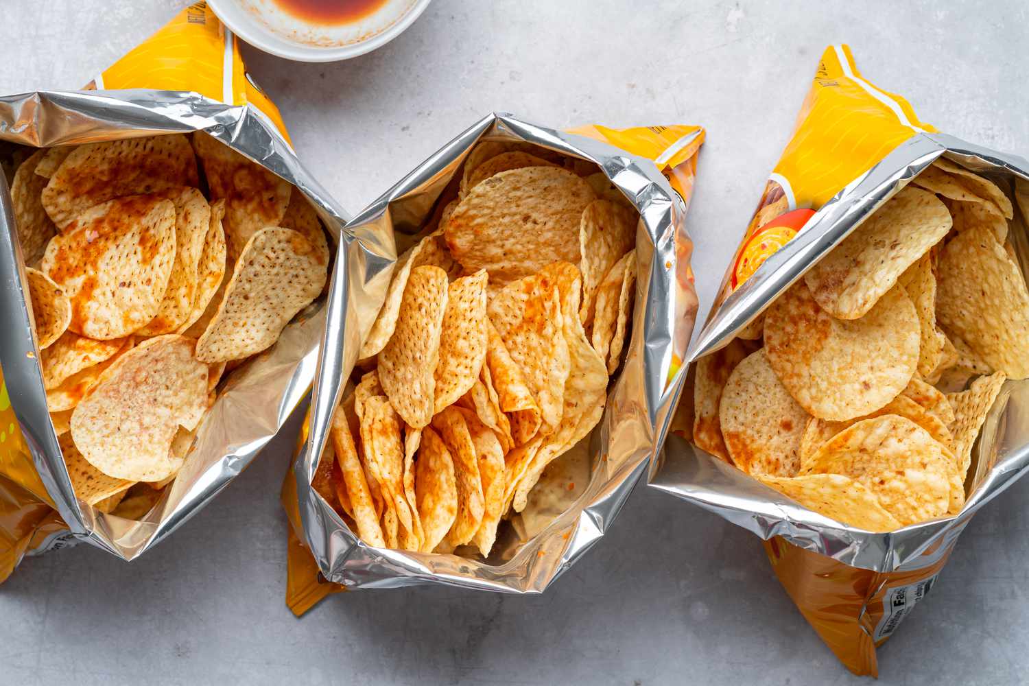 bags of tostitos with V8 sauce poured inside