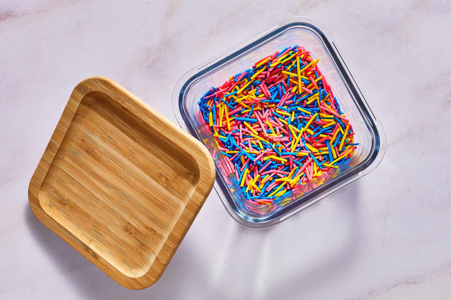 A container fulled with homemade sprinkles and a lid