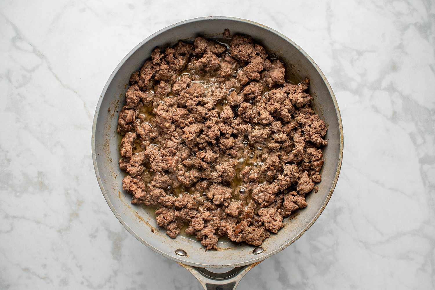 Lightly browned ground beef in a large skillet