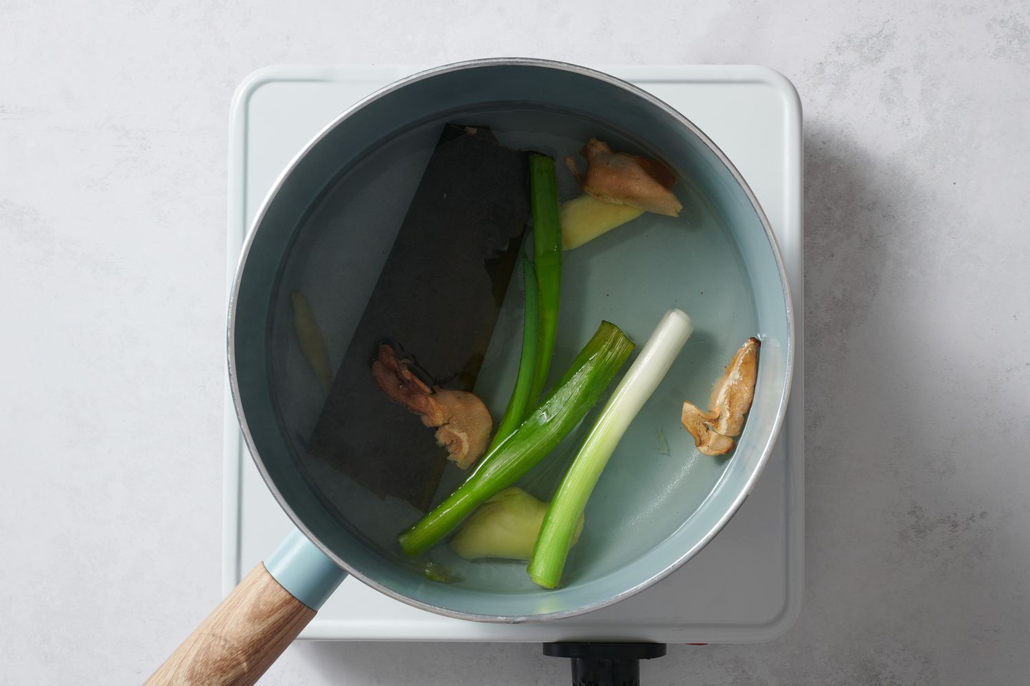 dashi ingredients in small pot on heat