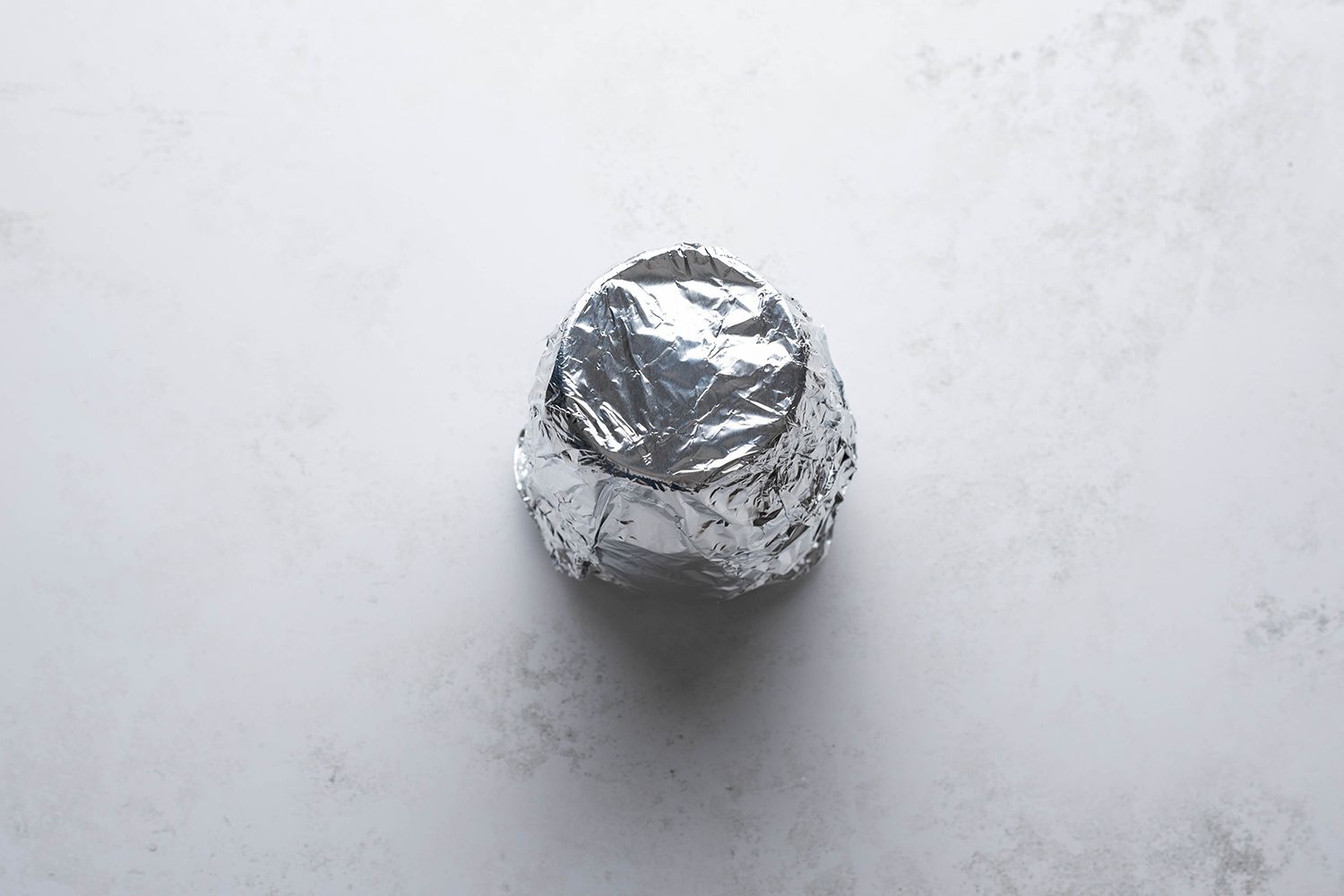 Lemon mixture in a glass container, covered with aluminum foil 