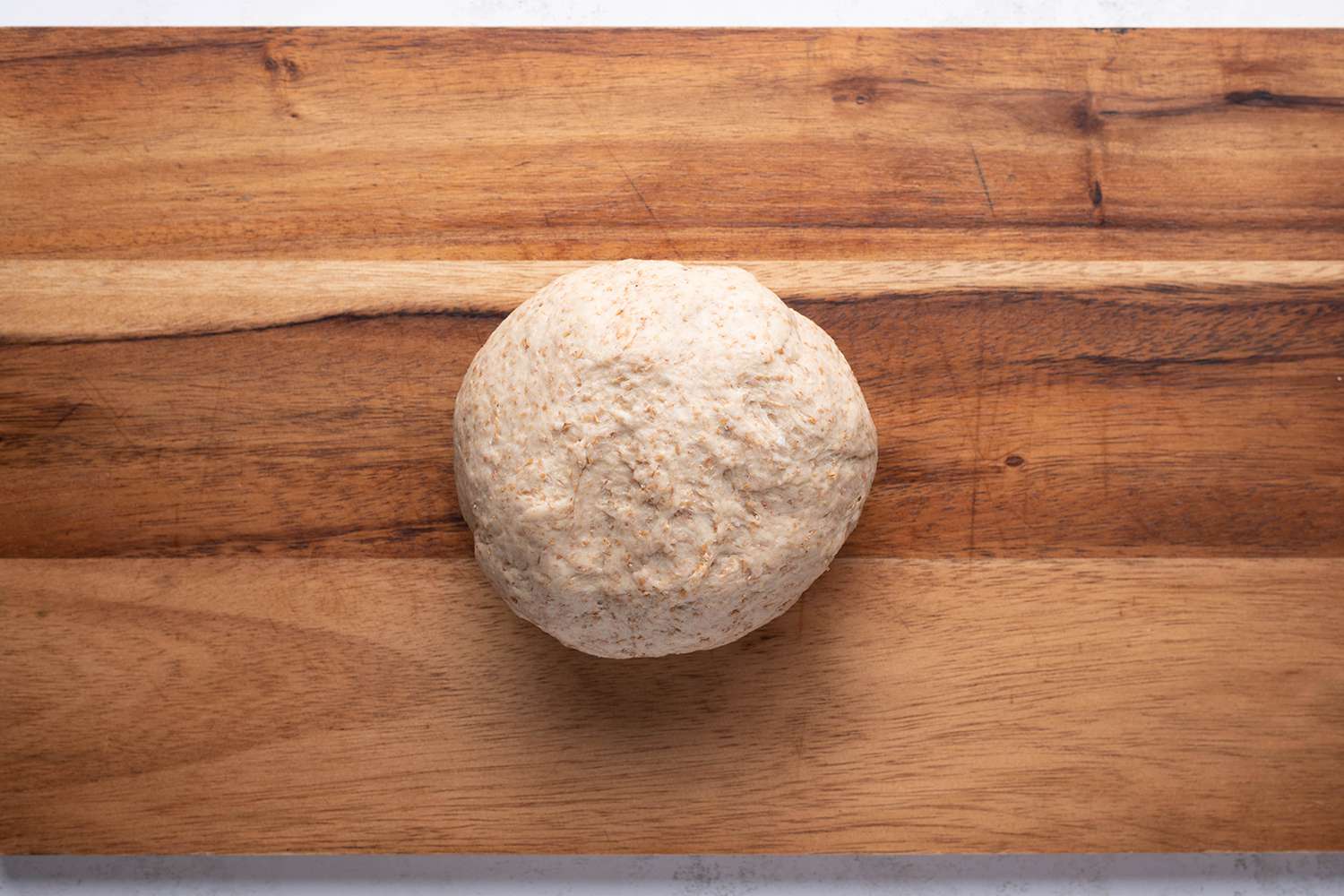 Dough ball on a wood cutting board 