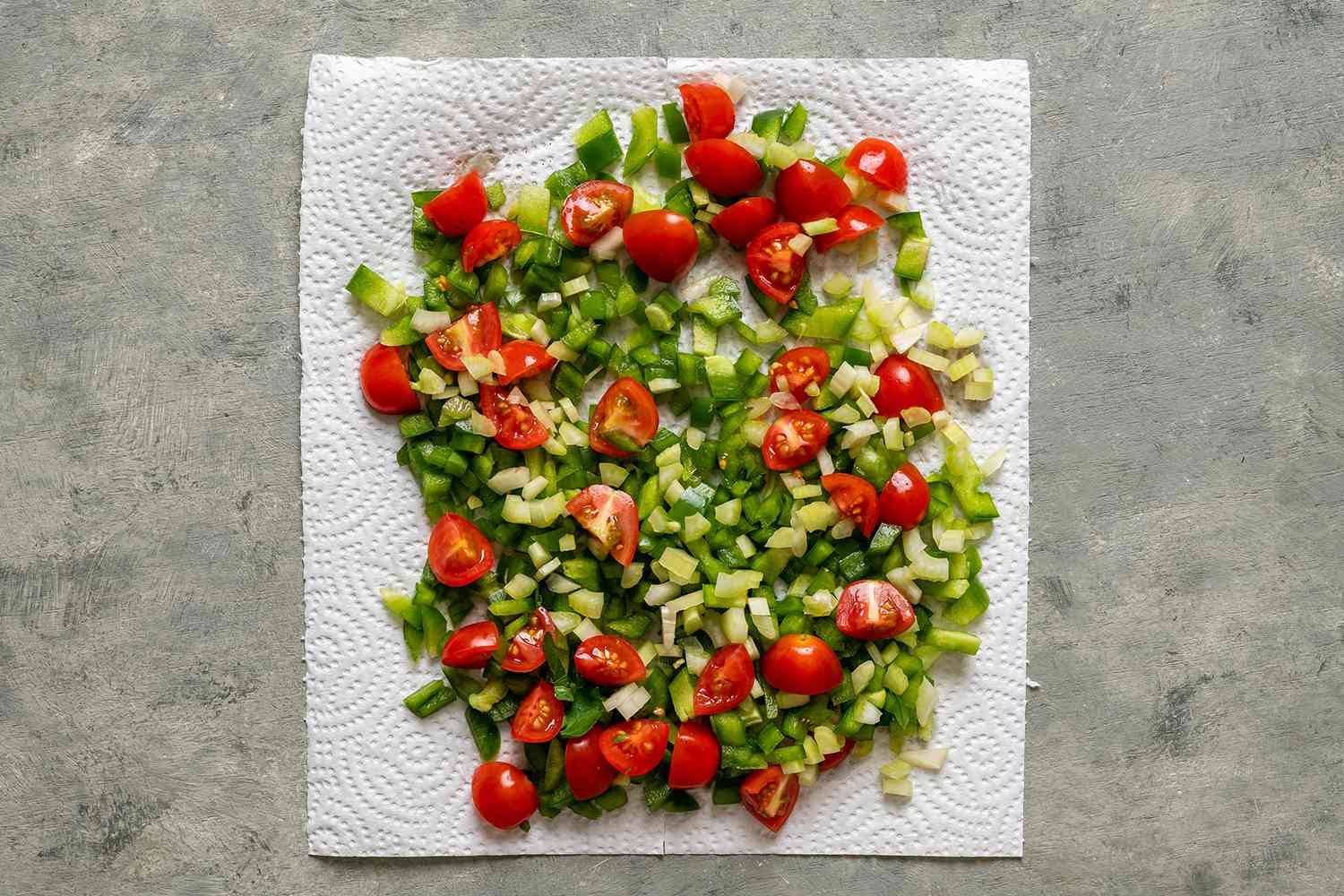 Bell pepper, celery, and cherry tomatoes on a paper towel 