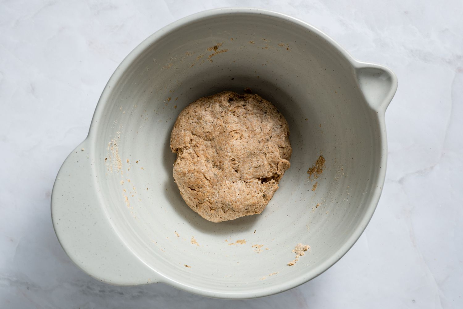 A bowl of mathri dough, with slight cracks around the edges