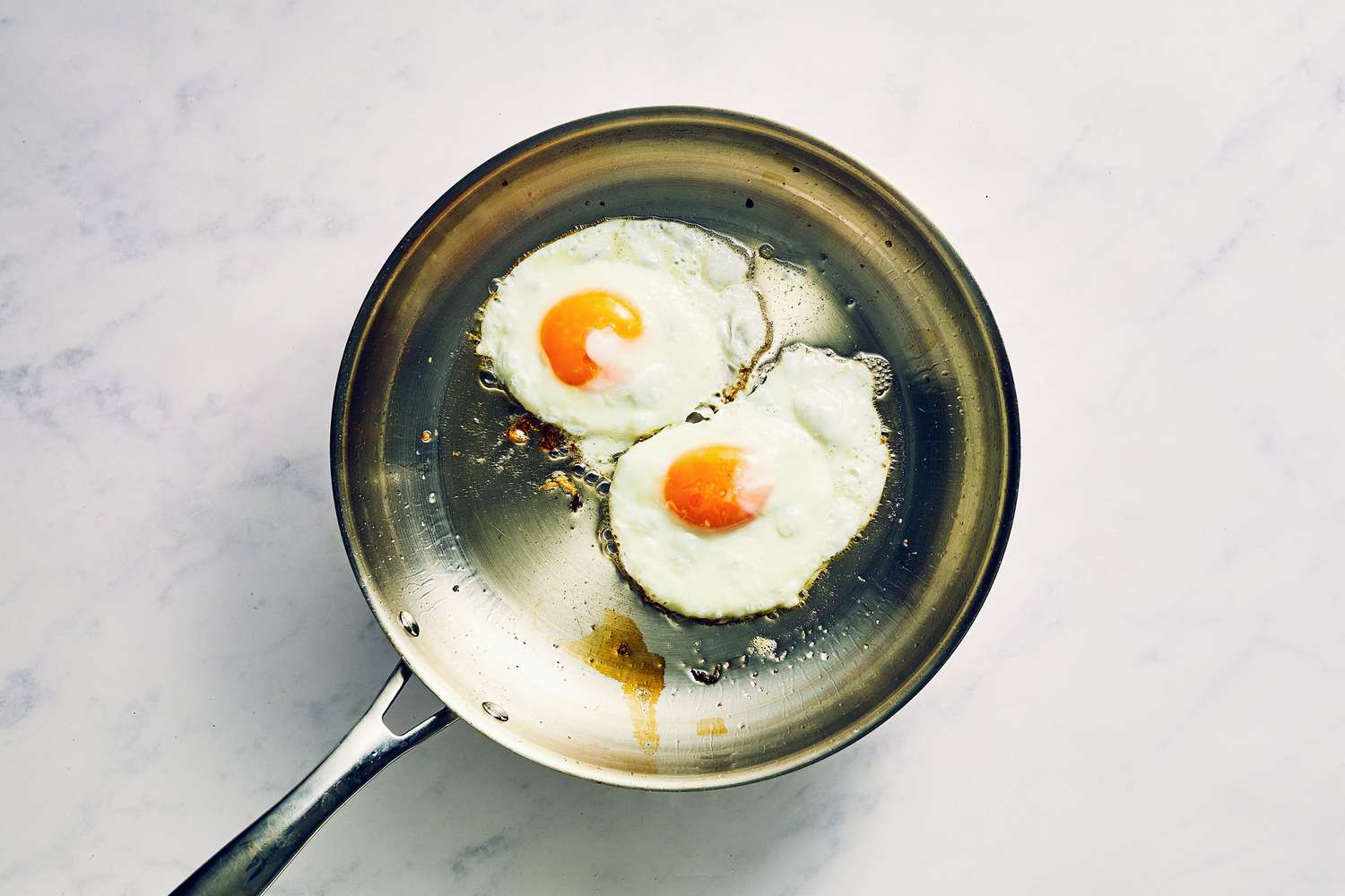 A small skillet with two fried eggs