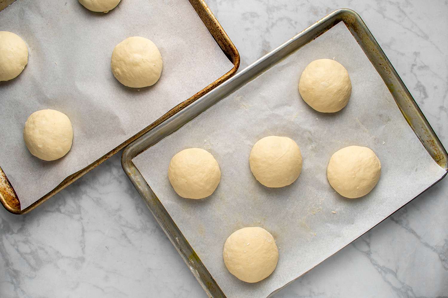 Potato dough shaped into balls on a baking sheet
