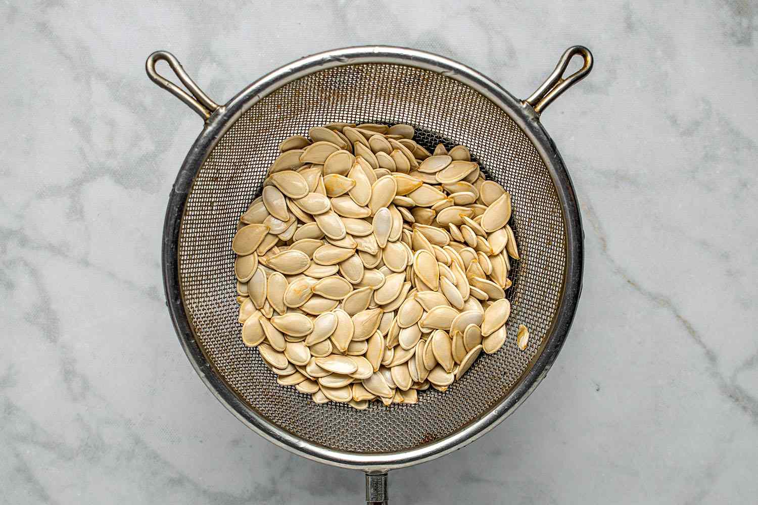 pumpkin seeds in a strainer