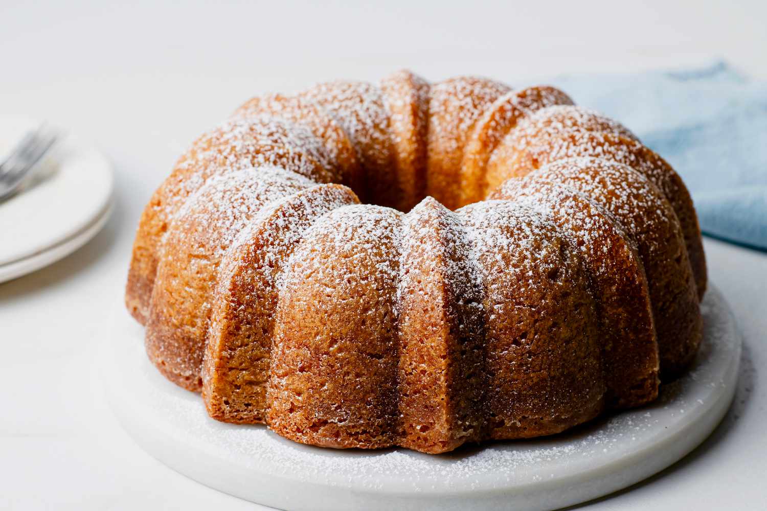 Kentucky butter bundt cake turned on a serving plate and dusted with confectioners' sugar