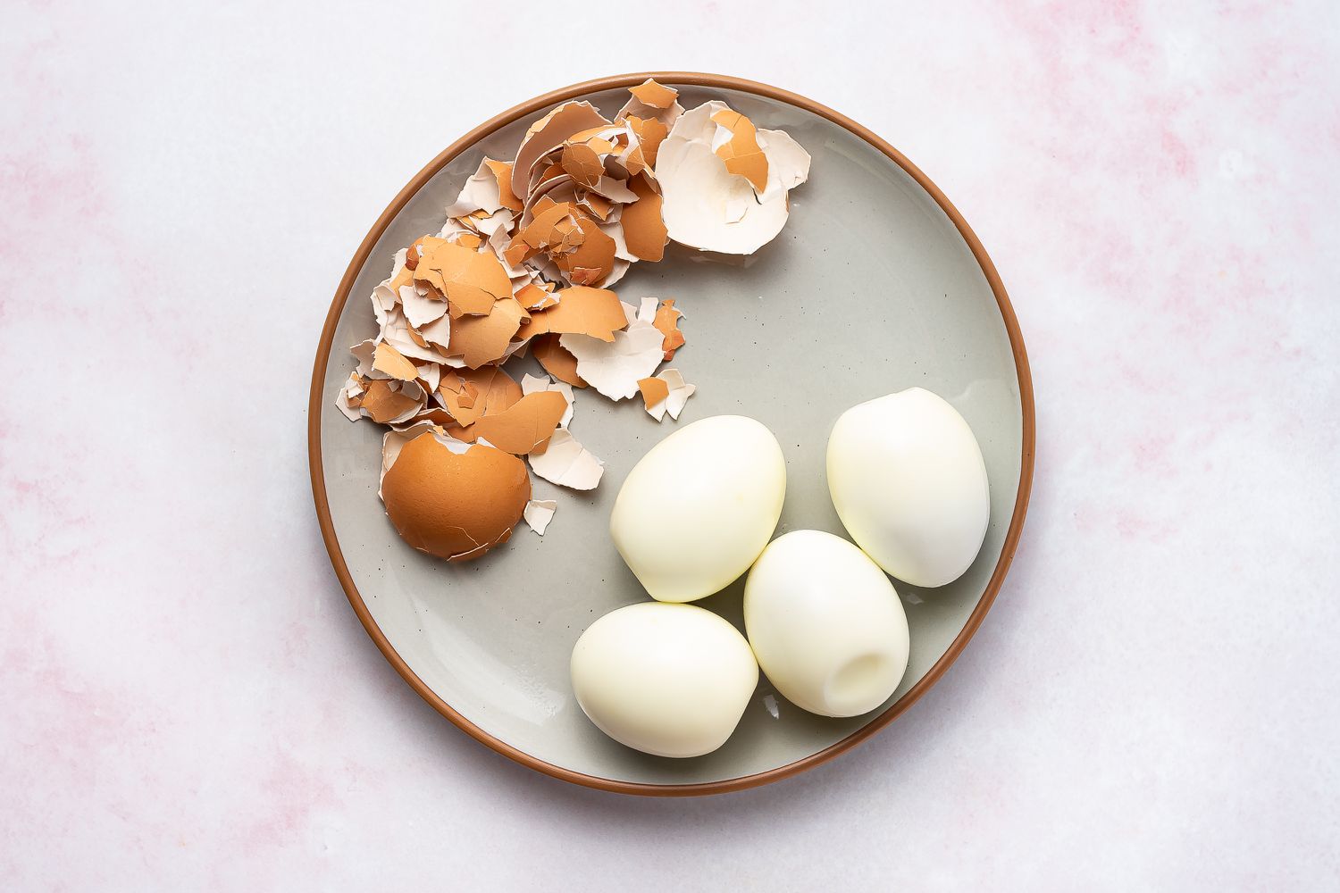 peeled hard boiled eggs on a plate 