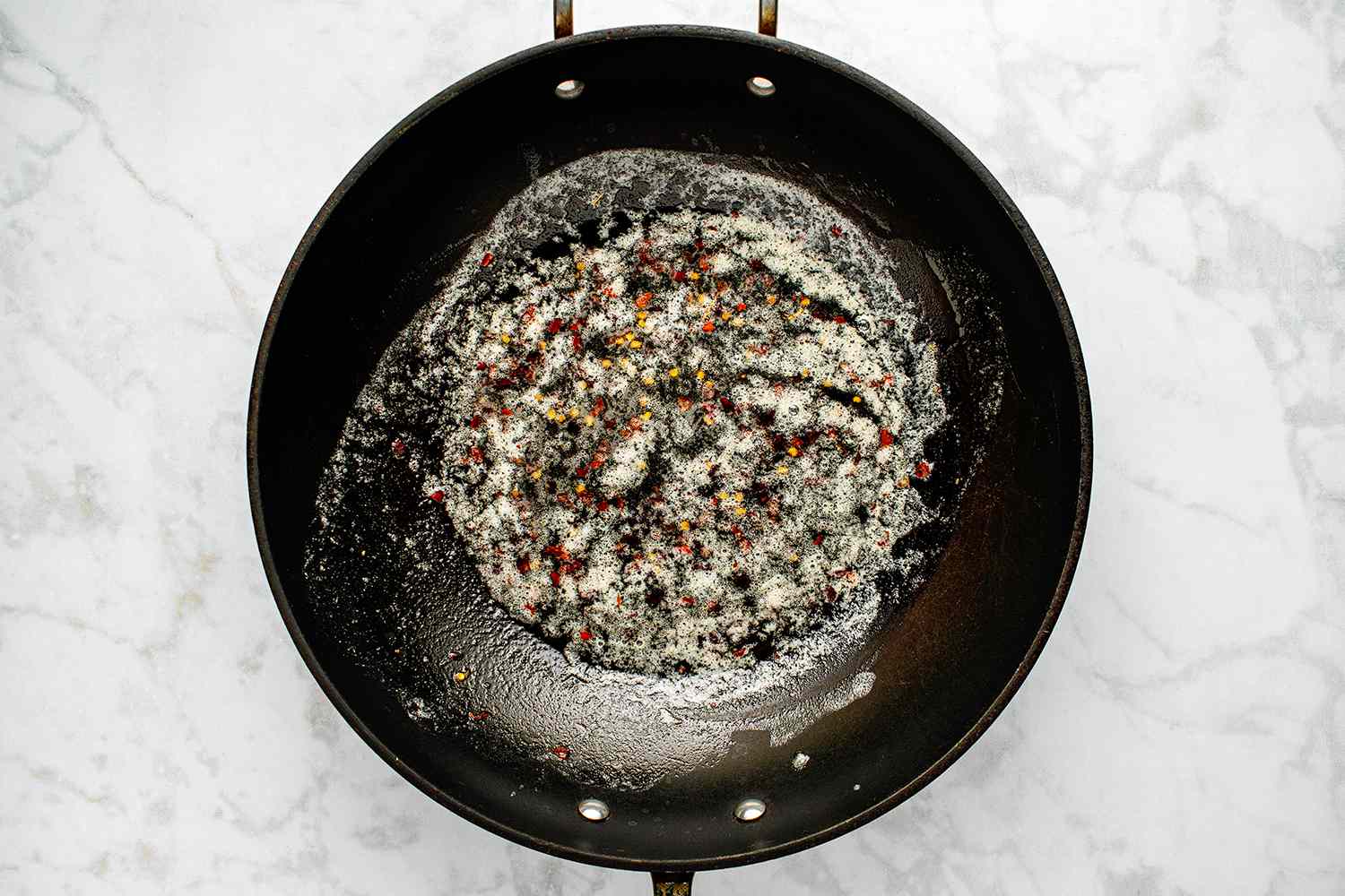 Crushed red pepper in a pan with butter 