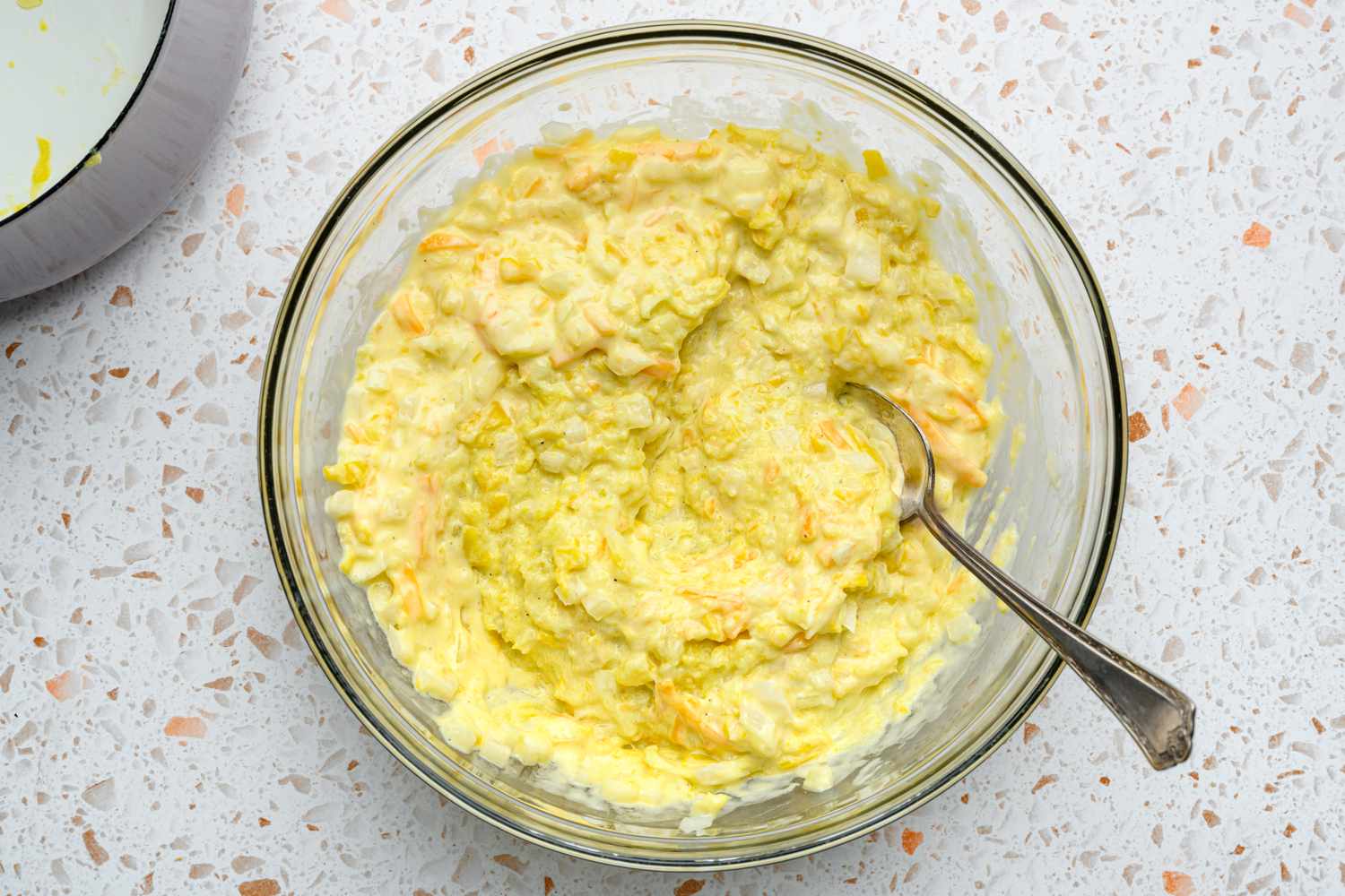 A bowl of mashed yellow squash mixed into the egg-mayonnaise mixture