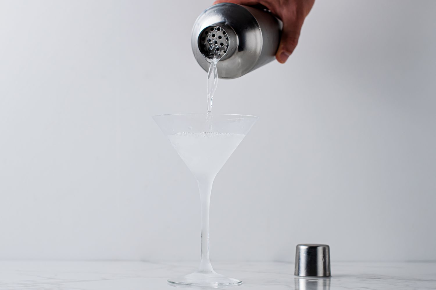 Straining the Vesper martini into a glass