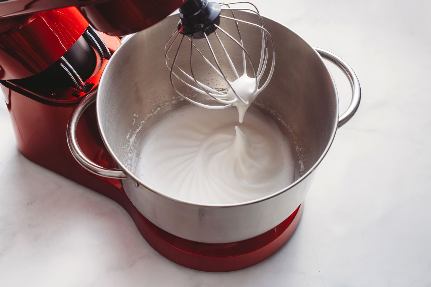 Egg whites and sugar beaten to soft peaks in a stand mixer 