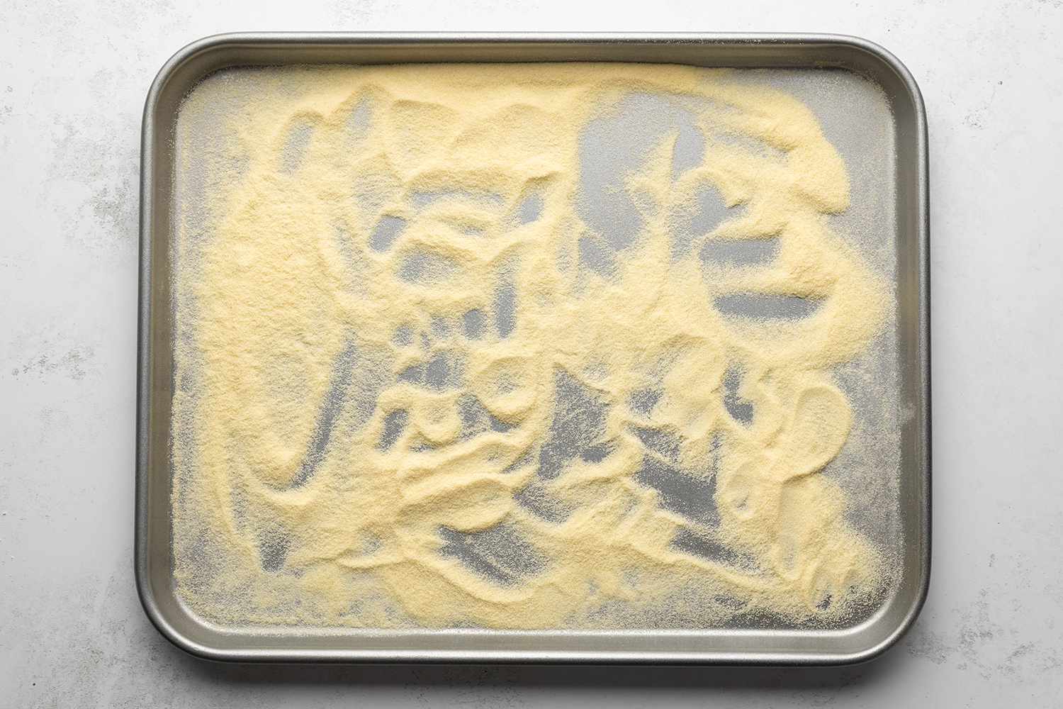 Semolina flour in a rimmed baking sheet