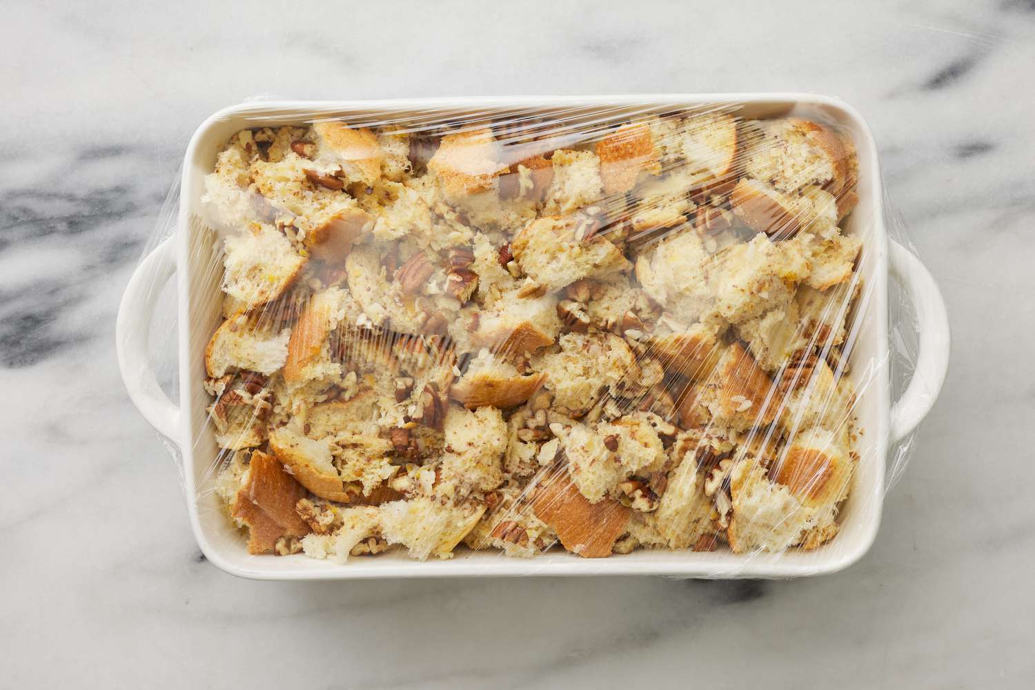 casserole with soaked bread cubes removed from fridge 