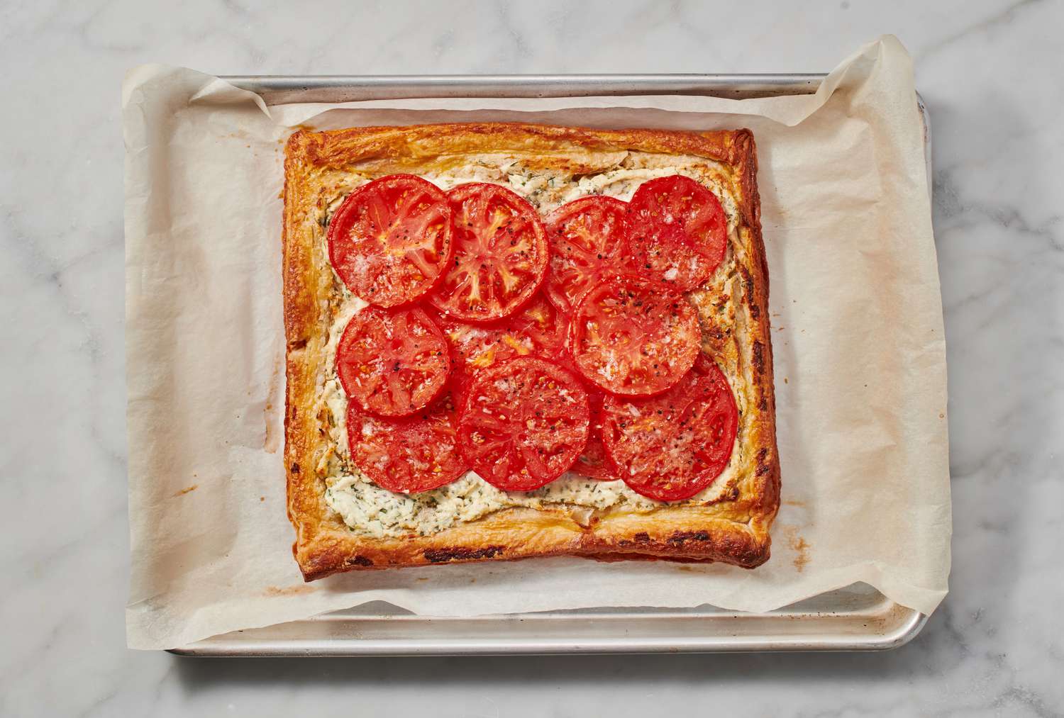 A fully baked puff pastry tomato tart