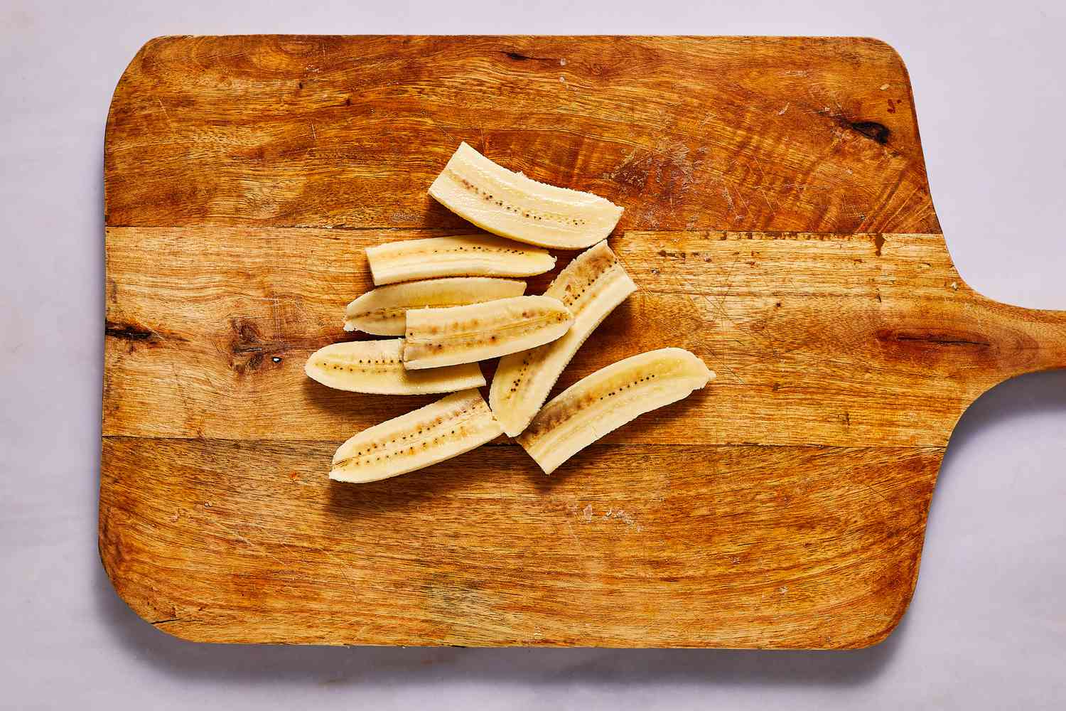 sliced raw bananas on a cutting board