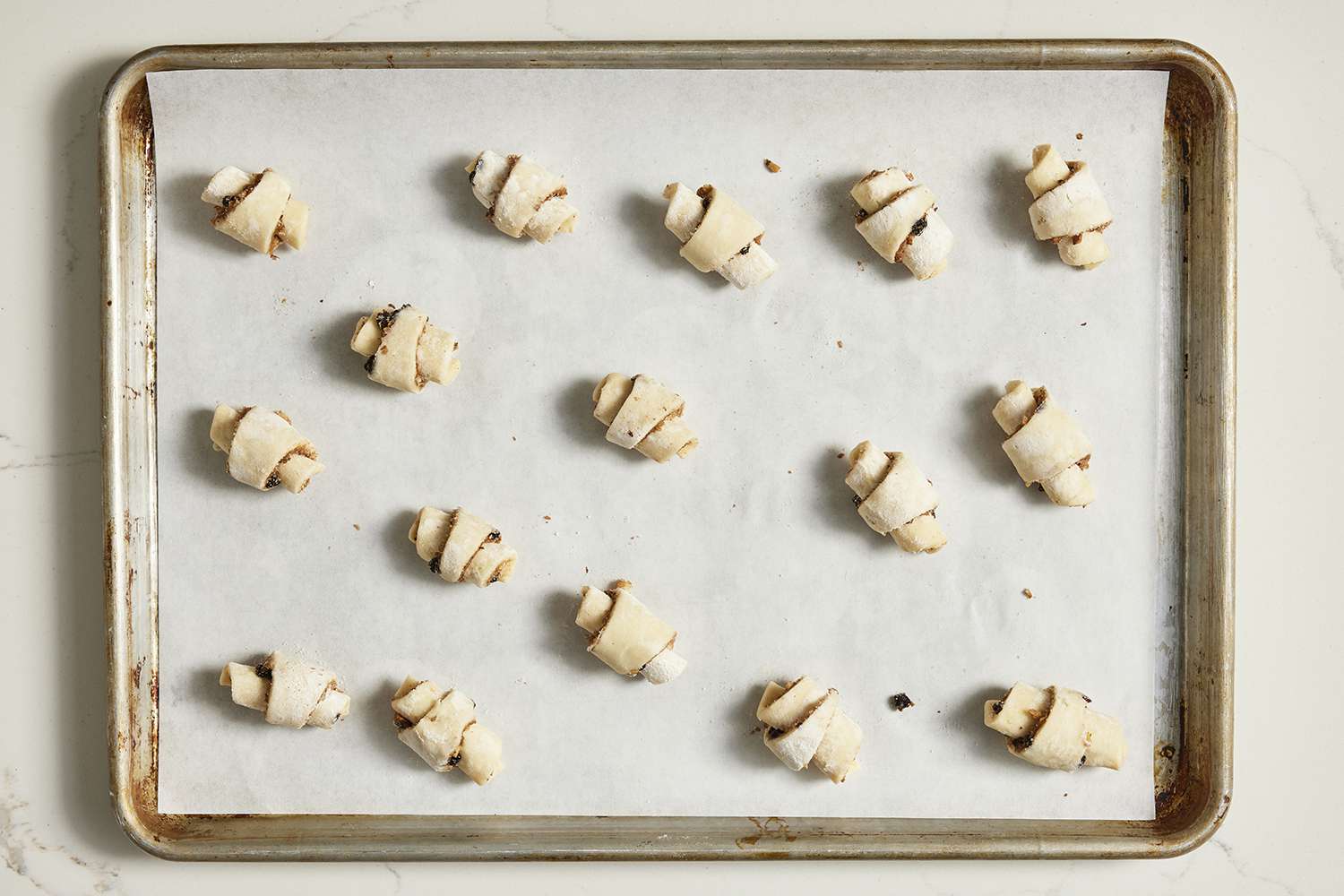 rugelach ready to bake on parchment lined baking sheet