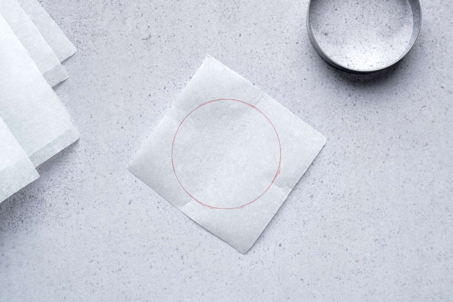 A square sheet of parchment paper with a circle
