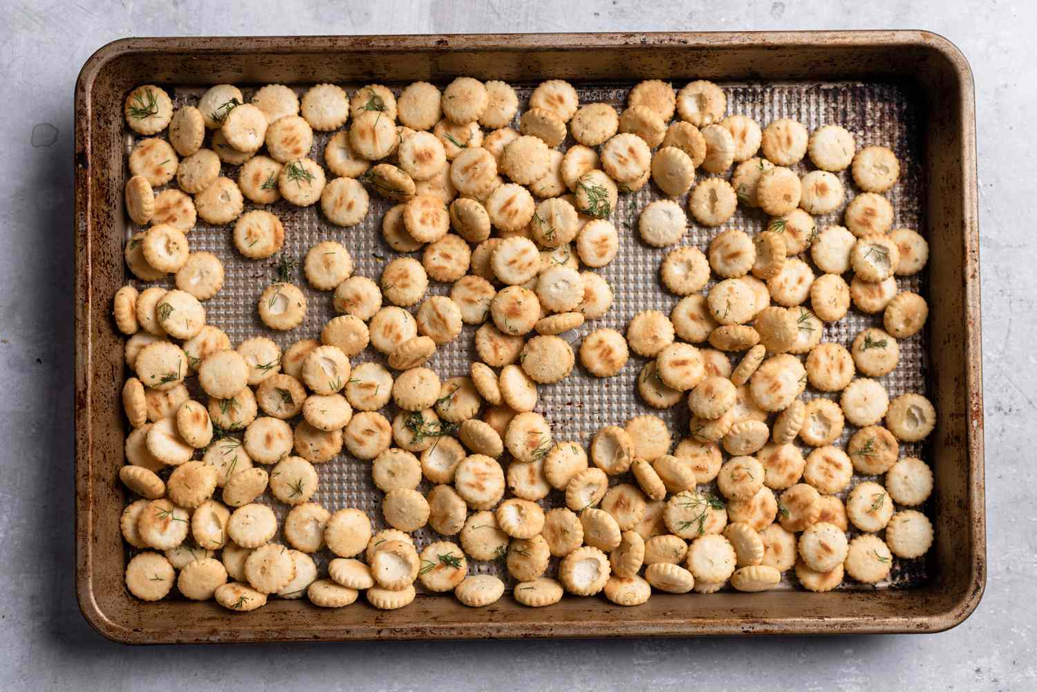 Baked seasoned oyster crackers on a baking sheet