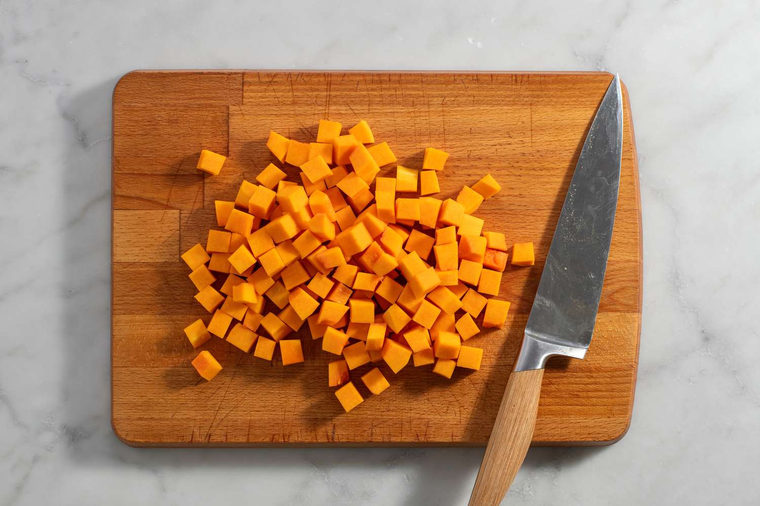 peeled and cubed butternut squash on cutting board