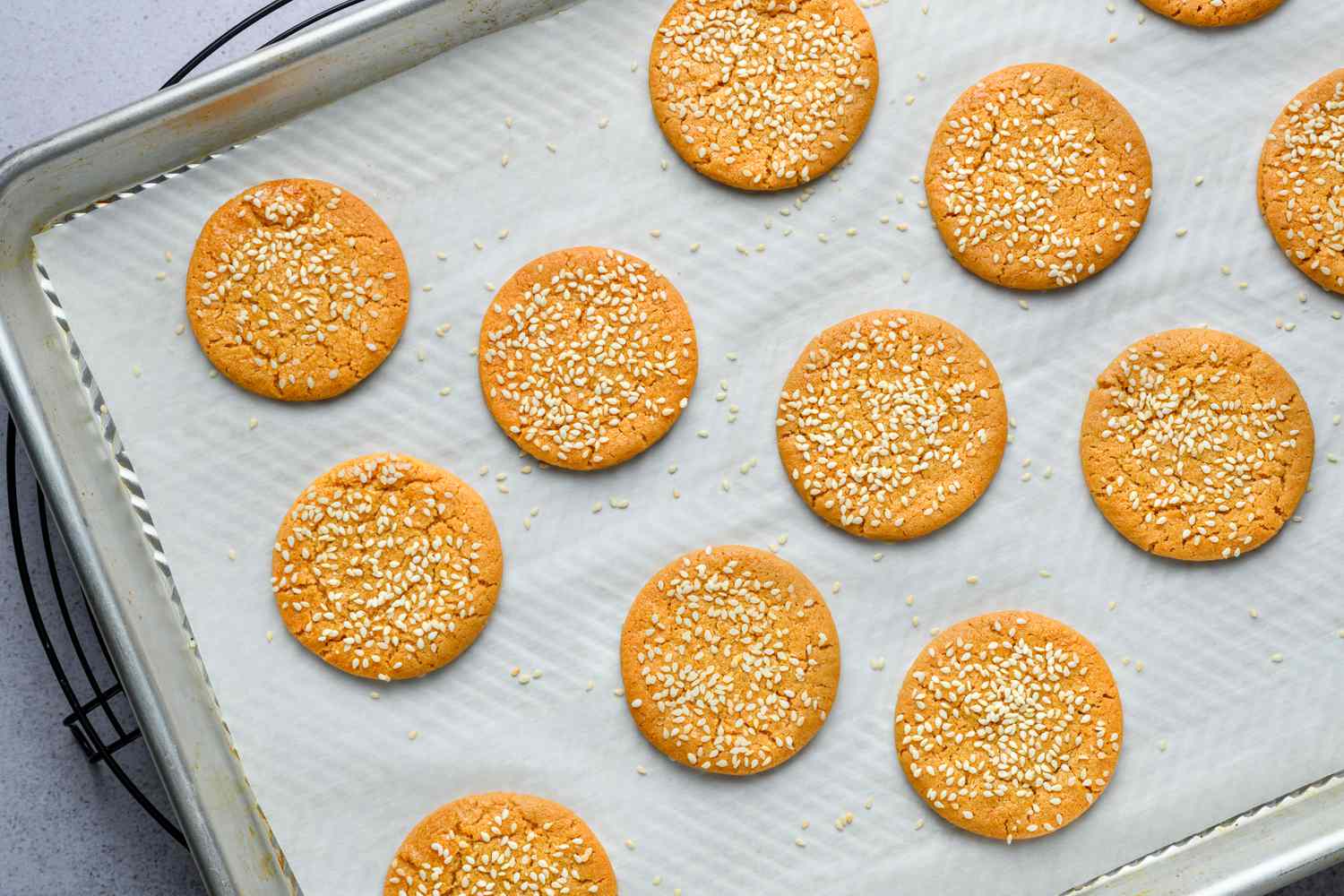 baked miso peanut butter cookies cooling on sheet tray on rack