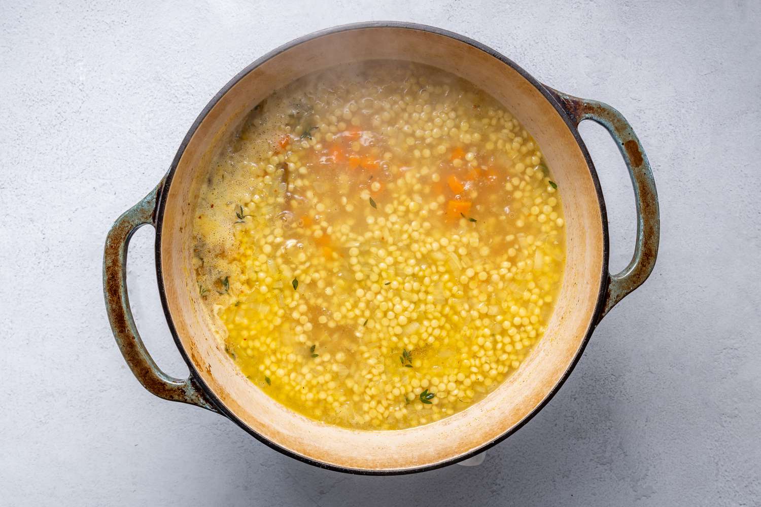 Toasted pasta soup simmering in a pot