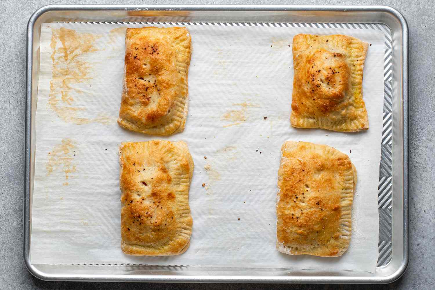 baked hot pockets on a lined baking sheet