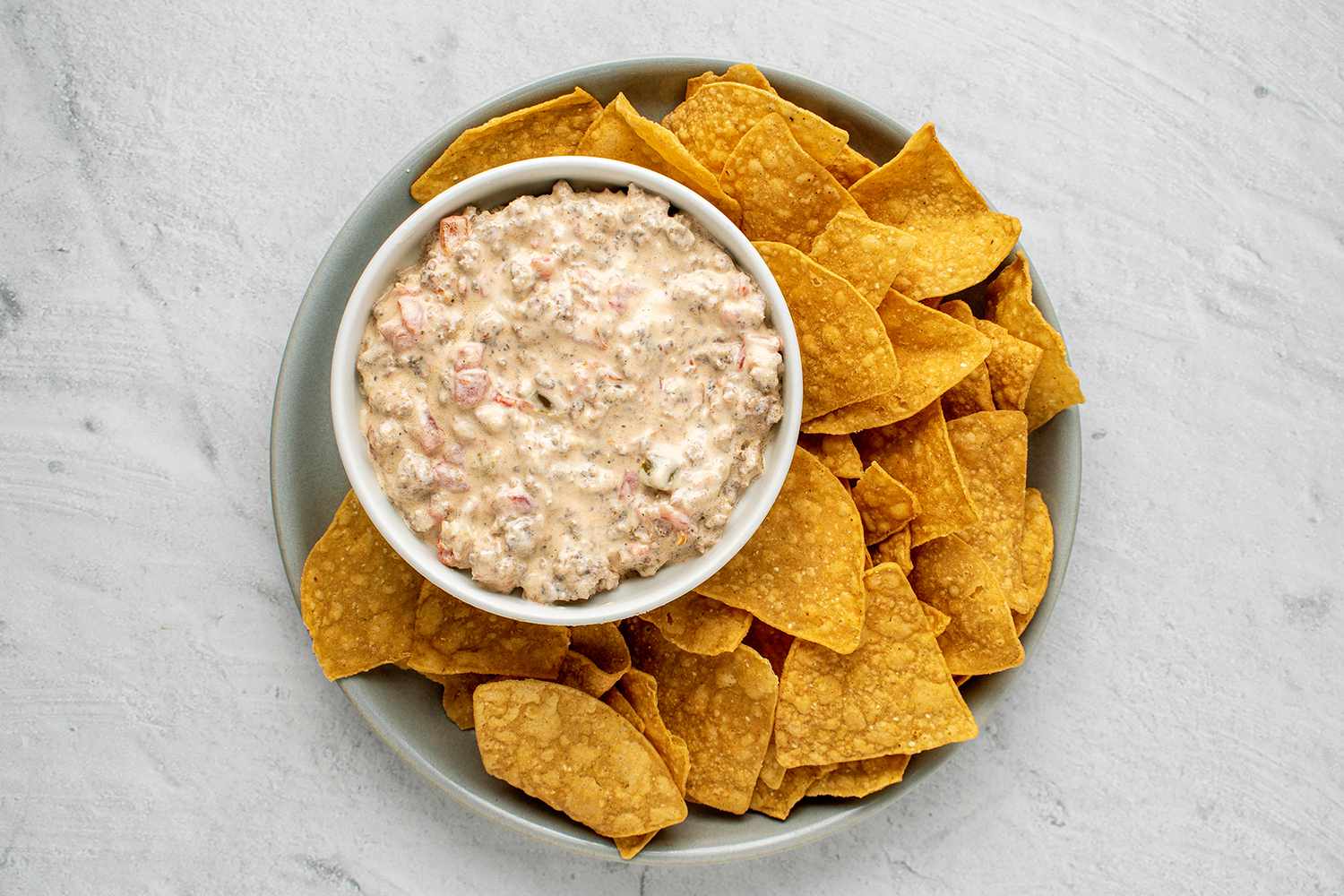 Sausage Dip in a bowl, served with chips 