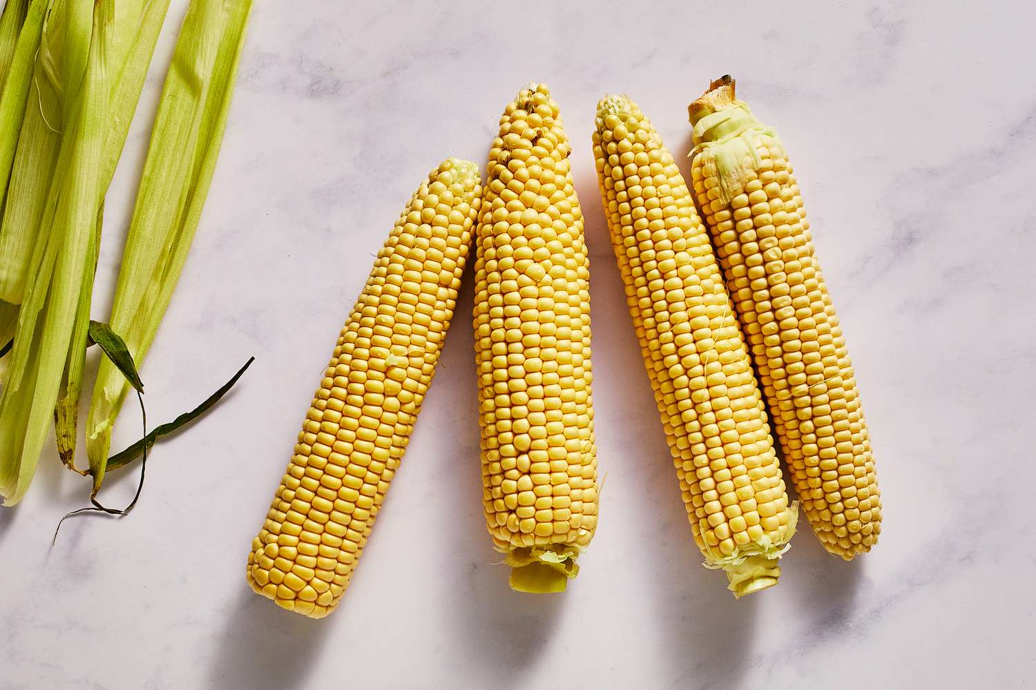Four shucked ears of corn