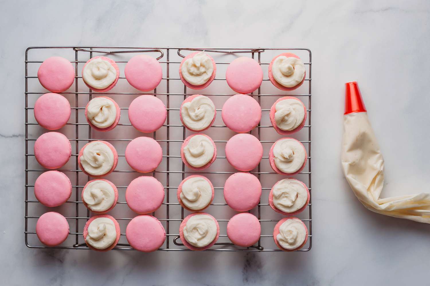 Flat side of half of the macarons covered with a circle of buttercream
