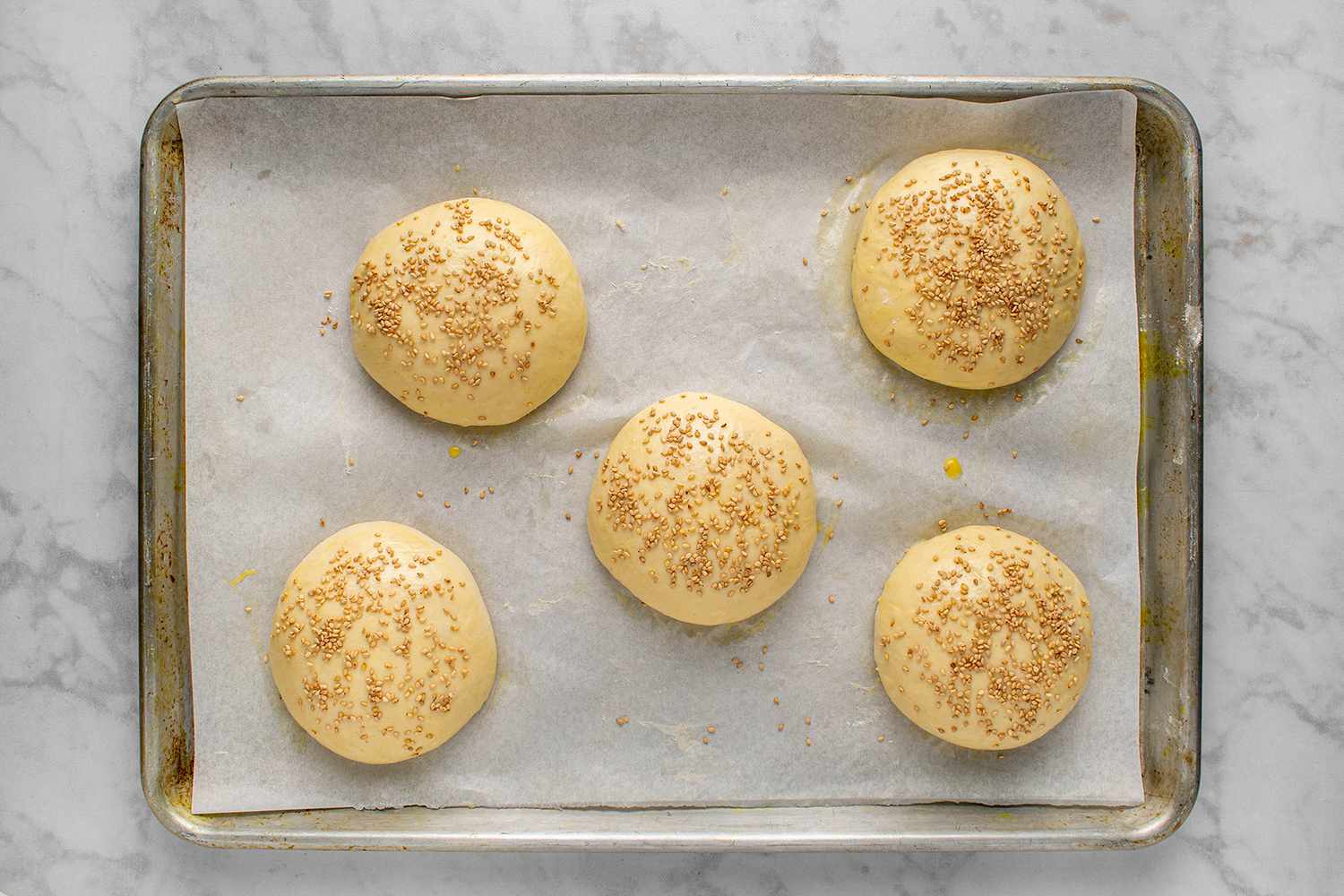 Raw potato dough buns sprinkled with sesame seeds