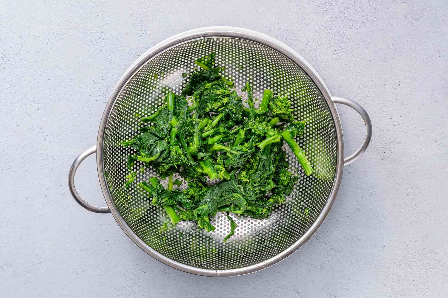 Cooked broccoli rabe in a colander